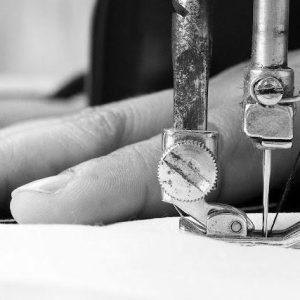 Woman hand, working with sewing machine, close up.